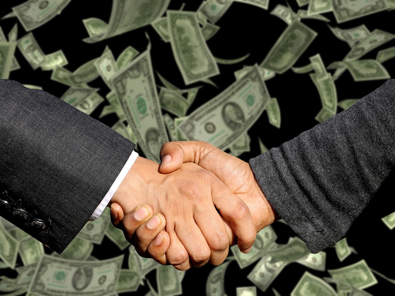 DJ and promoter handshake representing a booking deal