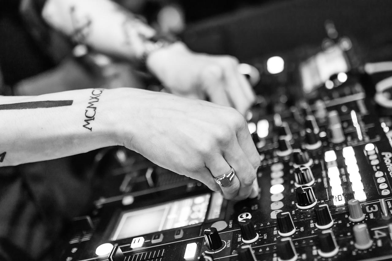 DJ mixing at a studio desk with headphones
